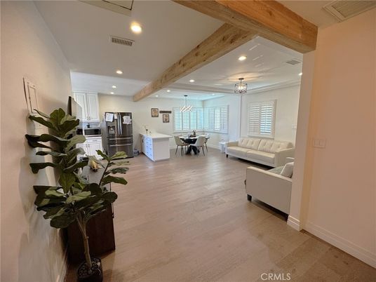 Chandelier, Dining room, Interior, Kitchen, Living room, Pendant Lights, Recessed Lighting, Stainless Steel Appliances, Wooden Beams, Wood Texture Flooring