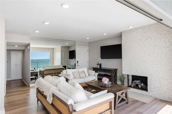 Fireplace, Interior, Living room, Marble Walls, Recessed Lighting, Water, Wood Texture Flooring