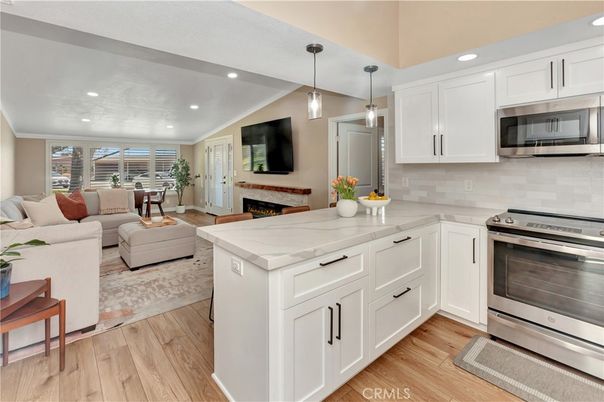 Fireplace, Interior, Kitchen, Living room, Pendant Lights, Recessed Lighting, Stainless Steel Appliances, Wood Texture Flooring