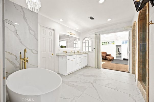 Bathroom, Chandelier, Dual Sink Vanities, Free Standing Baths, Glass Shower, Interior, Marble, Marble Walls, Recessed Lighting