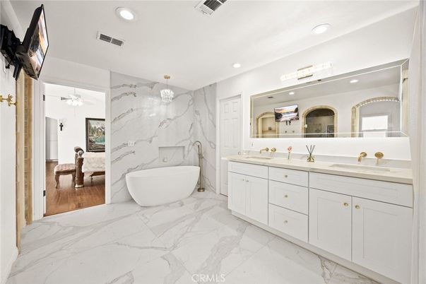 Bathroom, Dual Sink Vanities, Free Standing Baths, Interior, Marble, Marble Walls, Recessed Lighting, Wood Texture Flooring