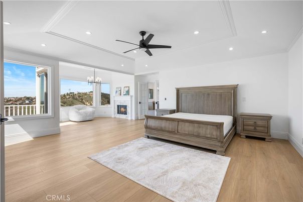 Bedroom, Chandelier, Fireplace, Interior, Recessed Lighting, Wood Texture Flooring