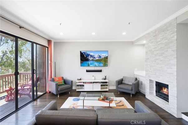 Fireplace, Interior, Living room, Recessed Lighting, Stone Walls, Wood Texture Flooring
