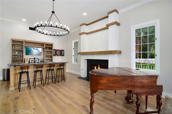 Chandelier, Fireplace, Interior, Pendant Lights, Piano, Recessed Lighting, Wood Texture Flooring