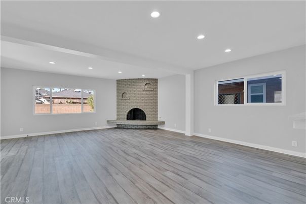 Empty room, Fireplace, Interior, Recessed Lighting, Stone Walls, Wood Texture Flooring