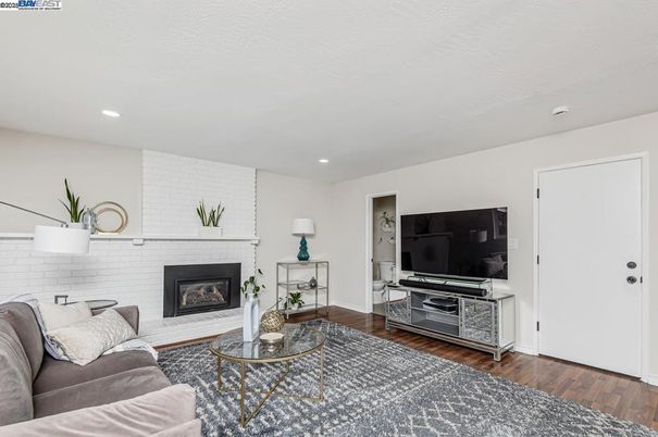 Fireplace, Interior, Living room, Recessed Lighting, Stone Walls, Wood Texture Flooring