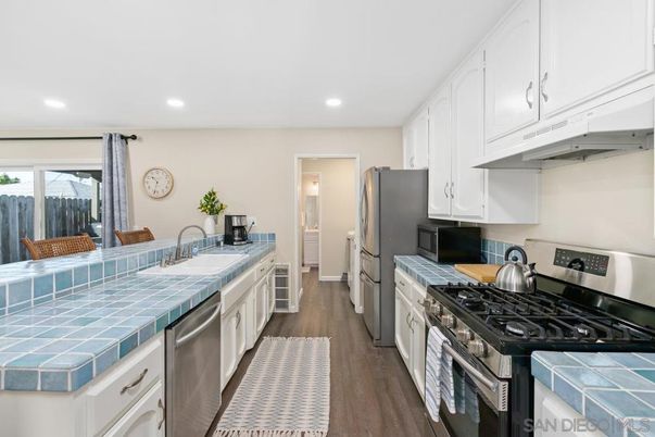 Interior, Kitchen, Recessed Lighting, Stainless Steel Appliances, Tile Countertops, Wood Texture Flooring