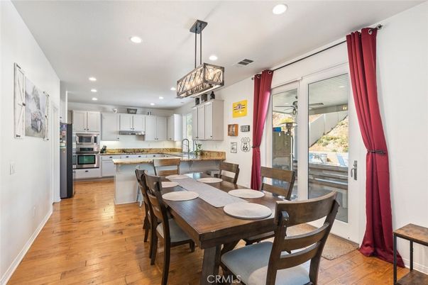 Dining room, Interior, Kitchen, Pendant Lights, Recessed Lighting, Stainless Steel Appliances, Wood Texture Flooring