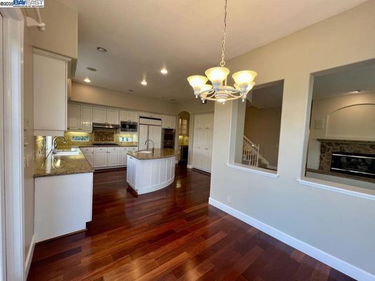 Chandelier, Fireplace, Interior, Kitchen, Pendant Lights, Recessed Lighting, Stainless Steel Appliances, Wood Texture Flooring