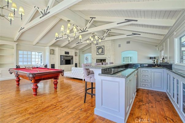Billiard Table, Chandelier, Fireplace, Game Room, Interior, Living room, Stone Walls, Wood Texture Flooring
