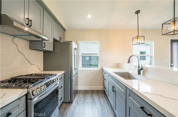 Interior, Kitchen, Marble Walls, Pendant Lights, Recessed Lighting, Stainless Steel Appliances, Wood Texture Flooring