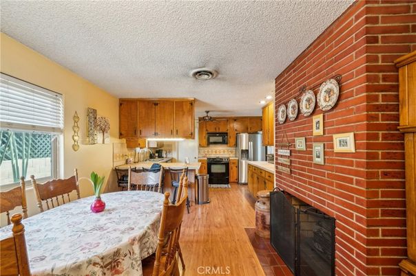 Dining room, Fireplace, Interior, Kitchen, Recessed Lighting, Stainless Steel Appliances, Stone Walls, Wood Texture Flooring