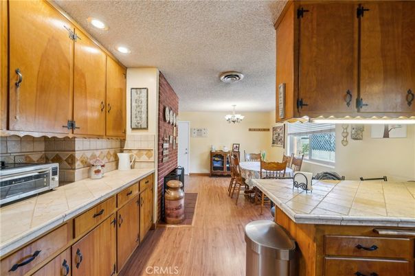 Chandelier, Dining room, Interior, Kitchen, Recessed Lighting, Tile Countertops, Wood Texture Flooring
