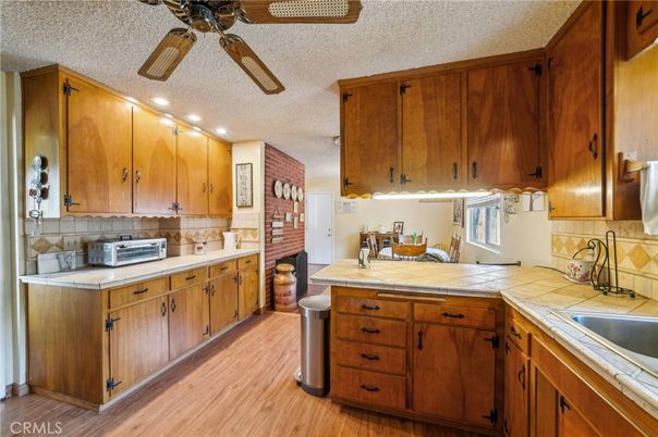 Interior, Kitchen, Recessed Lighting, Tile Countertops, Wood Texture Flooring
