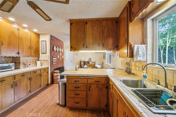 Interior, Kitchen, Recessed Lighting, Tile Countertops, Wood Texture Flooring