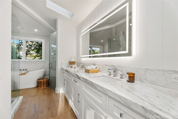 Bathroom, Dual Sink Vanities, Glass Shower, Interior, Marble Walls, Recessed Lighting, Wood Texture Flooring