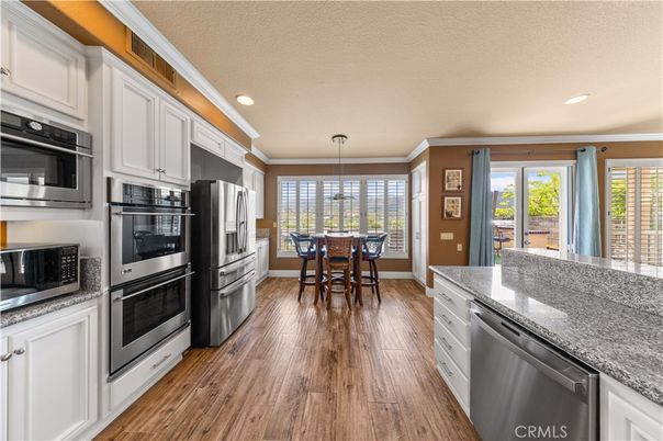 Dining room, Interior, Kitchen, Pendant Lights, Recessed Lighting, Stainless Steel Appliances, Wood Texture Flooring