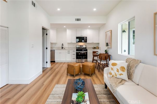 Dining room, Interior, Kitchen, Living room, Recessed Lighting, Stainless Steel Appliances, Wood Texture Flooring