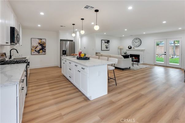 Fireplace, Interior, Kitchen, Living room, Pendant Lights, Recessed Lighting, Stainless Steel Appliances, Wood Texture Flooring