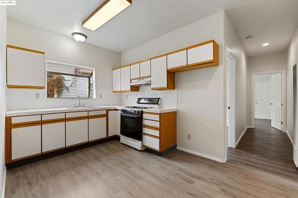 Interior, Kitchen, Recessed Lighting, Tile Countertops, Wood Texture Flooring