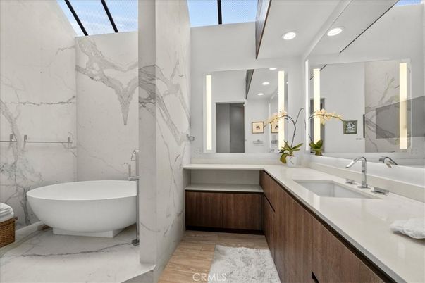 Bathroom, Dual Sink Vanities, Free Standing Baths, Interior, Marble, Marble Walls, Recessed Lighting, Wood Texture Flooring