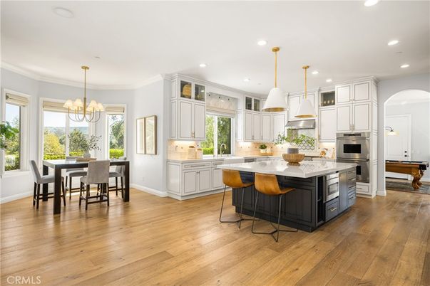 Chandelier, Dining room, Interior, Kitchen, Pendant Lights, Recessed Lighting, Stainless Steel Appliances, Wood Texture Flooring