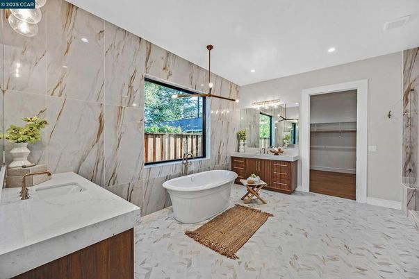 Bathroom, Dual Sink Vanities, Free Standing Baths, Interior, Marble, Marble Walls, Pendant Lights, Recessed Lighting, Wood Texture Flooring