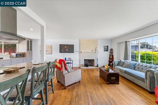 Dining room, Fireplace, Interior, Living room, Recessed Lighting, Stone Walls, Wood Texture Flooring