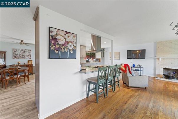 Dining room, Fireplace, Interior, Kitchen, Living room, Recessed Lighting, Stone Walls, Wood Texture Flooring