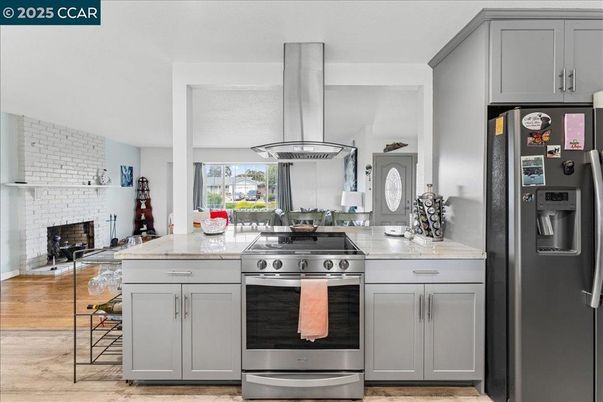 Fireplace, Interior, Kitchen, Stainless Steel Appliances, Stone Walls, Wood Texture Flooring