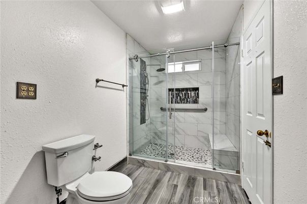 Bathroom, Glass Shower, Interior, Marble Walls, Recessed Lighting, Wood Texture Flooring