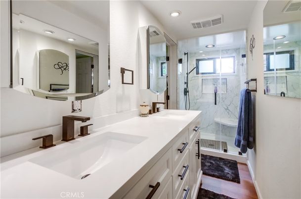 Bathroom, Dual Sink Vanities, Glass Shower, Interior, Marble Walls, Recessed Lighting, Wood Texture Flooring