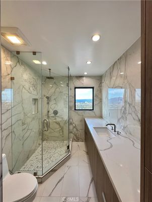 Bathroom, Dual Sink Vanities, Glass Shower, Interior, Marble, Marble Walls, Recessed Lighting