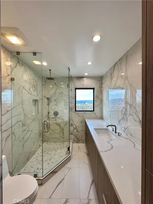 Bathroom, Dual Sink Vanities, Glass Shower, Interior, Marble, Marble Walls, Recessed Lighting
