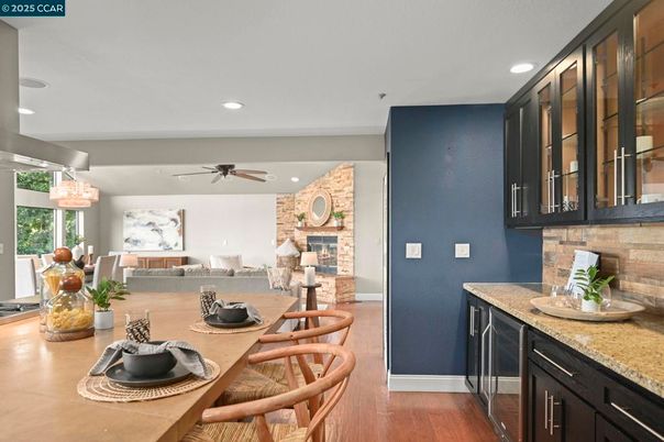 Dining room, Fireplace, Interior, Living room, Recessed Lighting, Stone Walls, Wood Texture Flooring