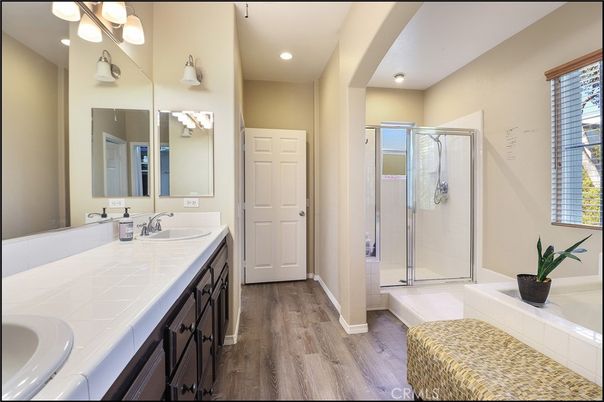 Bathroom, Dual Sink Vanities, Glass Shower, Interior, Recessed Lighting, Tile Countertops, Wood Texture Flooring