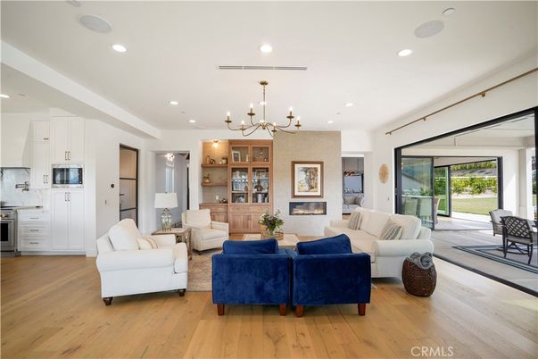 Chandelier, Fireplace, Interior, Kitchen, Living room, Pendant Lights, Recessed Lighting, Wood Texture Flooring