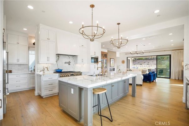 Chandelier, Interior, Kitchen, Living room, Marble Walls, Pendant Lights, Recessed Lighting, Stainless Steel Appliances, Wood Texture Flooring