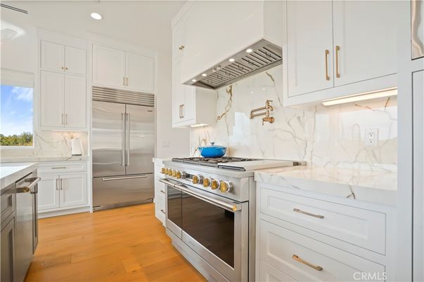 Interior, Kitchen, Marble Walls, Recessed Lighting, Stainless Steel Appliances, Wood Texture Flooring