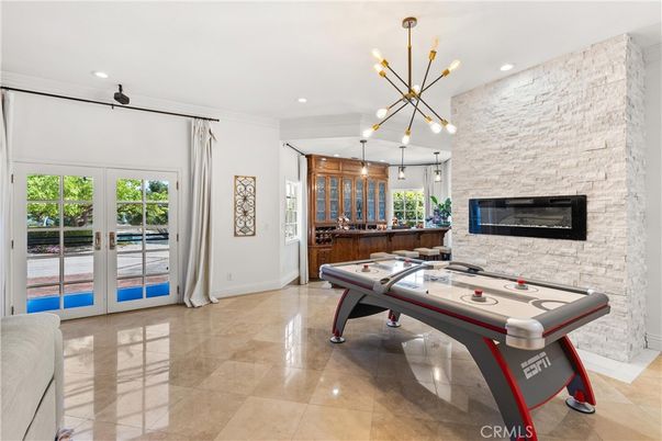 Fireplace, Game Room, Interior, Pendant Lights, Recessed Lighting, Stone Walls
