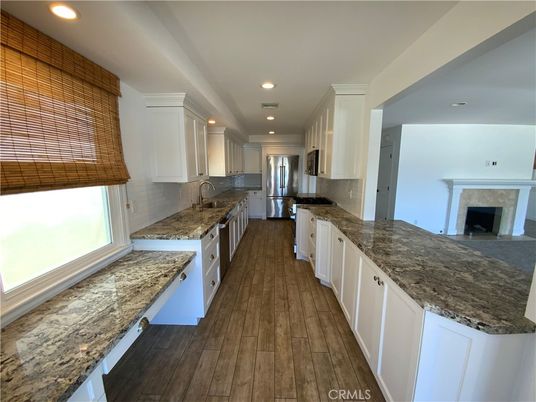 Fireplace, Interior, Kitchen, Recessed Lighting, Stainless Steel Appliances, Wood Texture Flooring