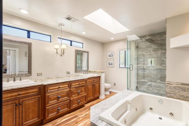 Bathroom, Dual Sink Vanities, Glass Shower, Interior, Pendant Lights, Recessed Lighting, Wood Texture Flooring