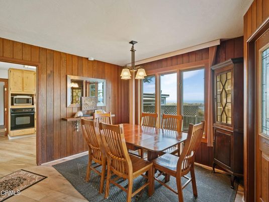 Dining room, Interior, Kitchen, Pendant Lights, Stainless Steel Appliances, Water, Wood Texture Flooring, Wooden Walls
