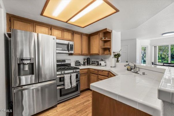 Interior, Kitchen, Stainless Steel Appliances, Tile Countertops, Wood Texture Flooring
