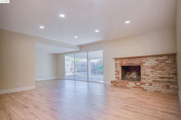 Empty room, Fireplace, Interior, Recessed Lighting, Stone Walls, Wood Texture Flooring
