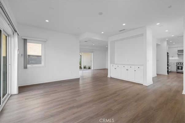 Empty room, Interior, Kitchen, Recessed Lighting, Stainless Steel Appliances, Wood Texture Flooring