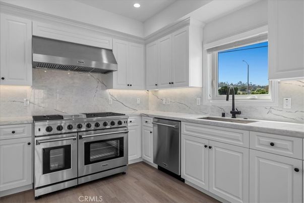 Interior, Kitchen, Marble Walls, Recessed Lighting, Stainless Steel Appliances, Wood Texture Flooring