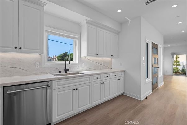 Interior, Kitchen, Marble Walls, Recessed Lighting, Stainless Steel Appliances, Wood Texture Flooring