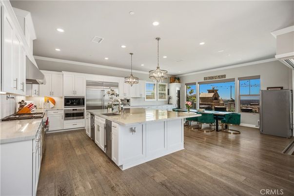 Chandelier, Dining room, Interior, Kitchen, Pendant Lights, Recessed Lighting, Stainless Steel Appliances, Wood Texture Flooring