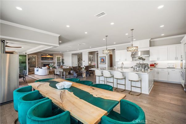 Chandelier, Dining room, Fireplace, Interior, Kitchen, Living room, Pendant Lights, Recessed Lighting, Stainless Steel Appliances, Wood Texture Flooring